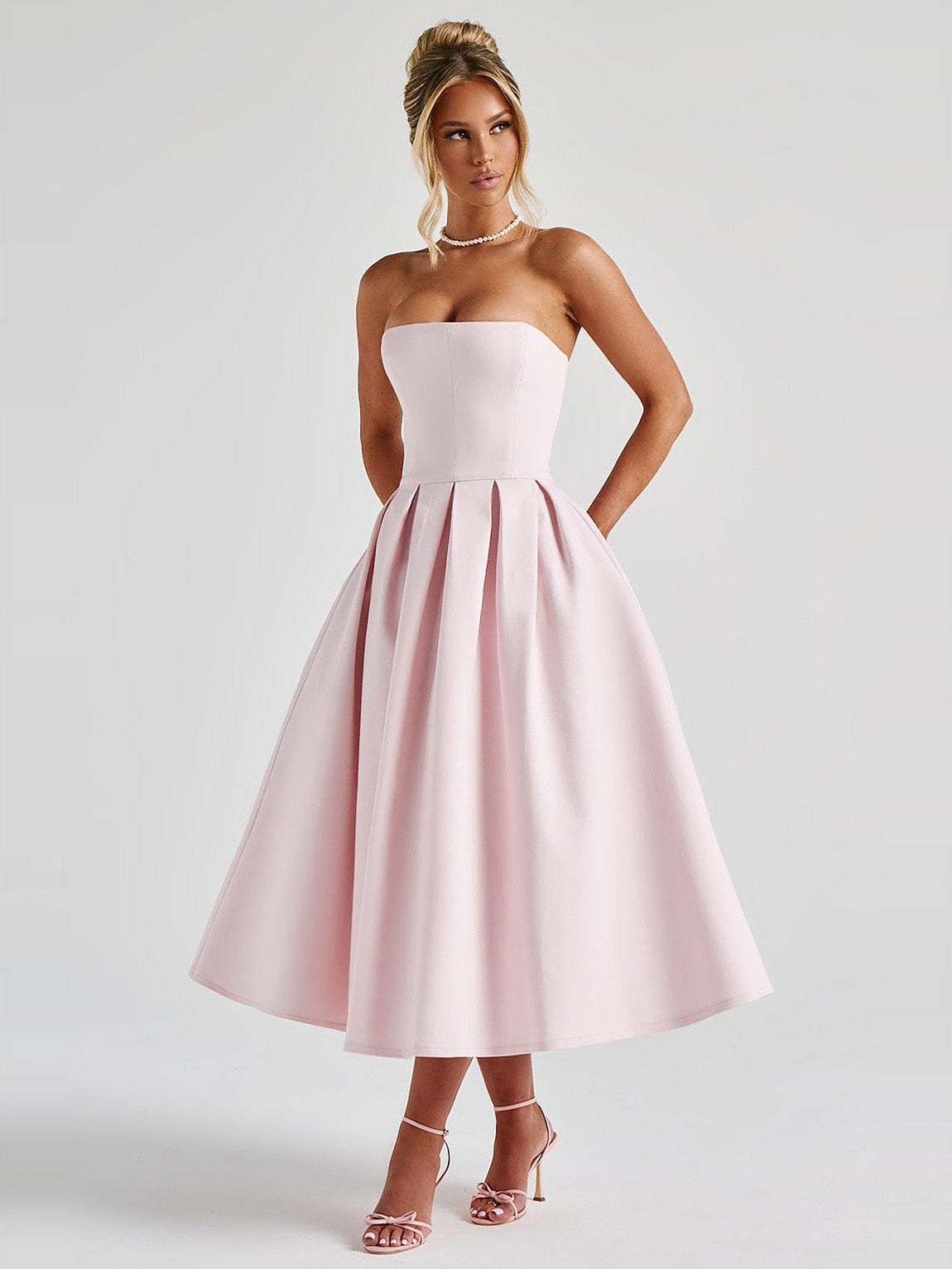 Edith Pleated Midi Dress in Blush — front, hands tucked